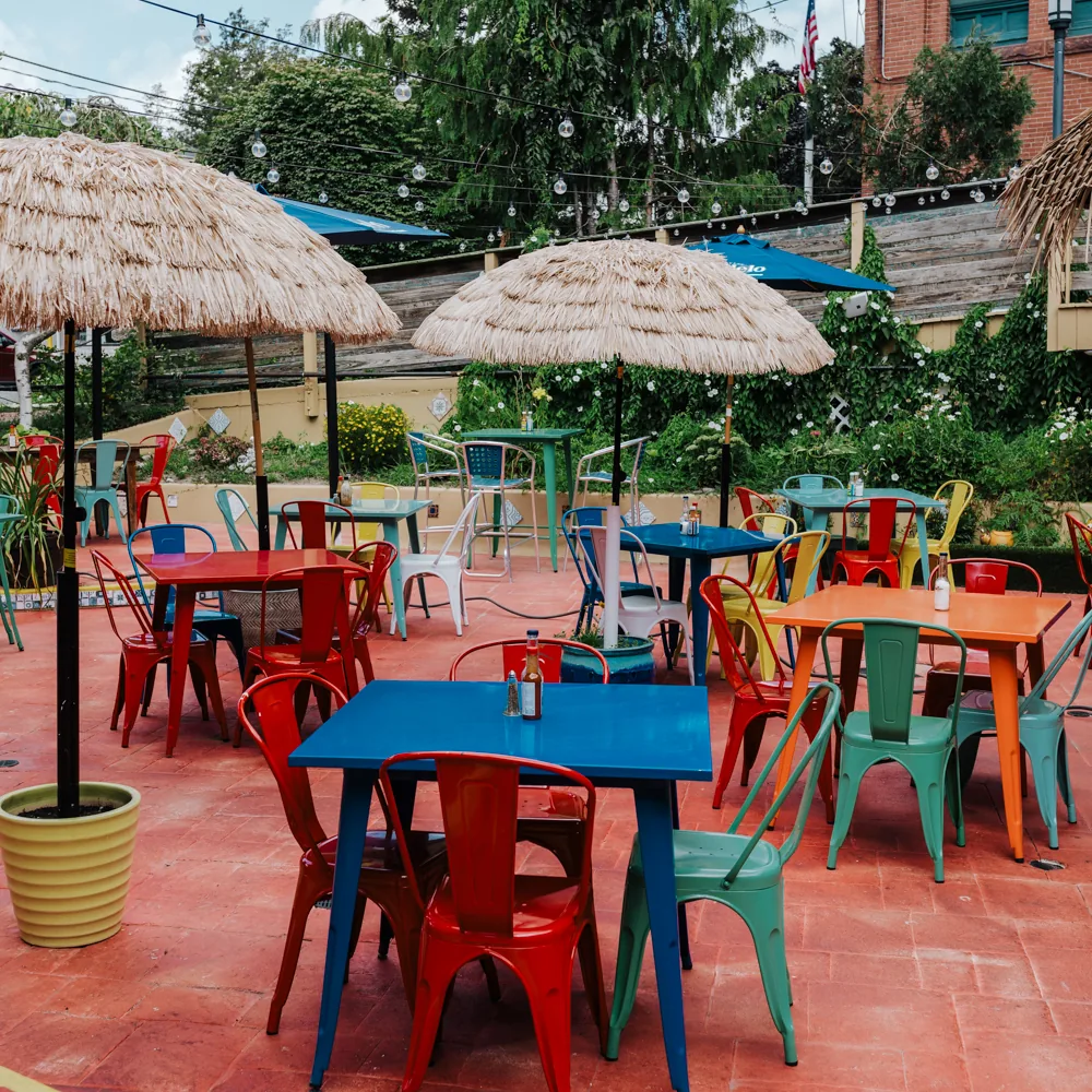 Colorful outdoor patio with thatched umbrellas